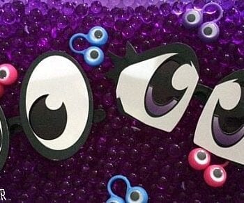 Eyeball sensory bin with purple water beads