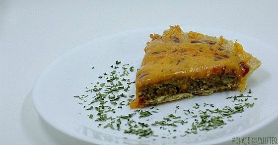 wedge of cheeseburger pie, topped with cheese and garnished with parsley
