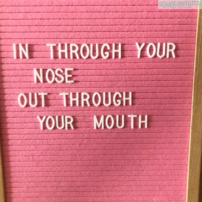 Pink felt board with the words "In through your nose, out through your mouth" in white letters