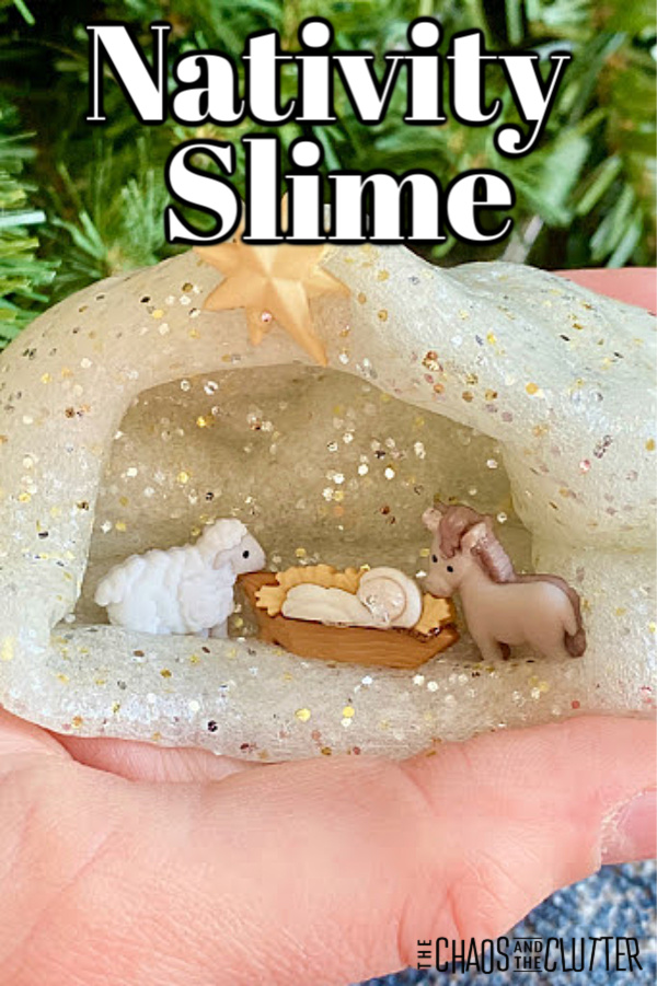 a tiny nativity scene sits inside a manger made out of slime on top of a child's hand with text that reads "Nativity Slime”