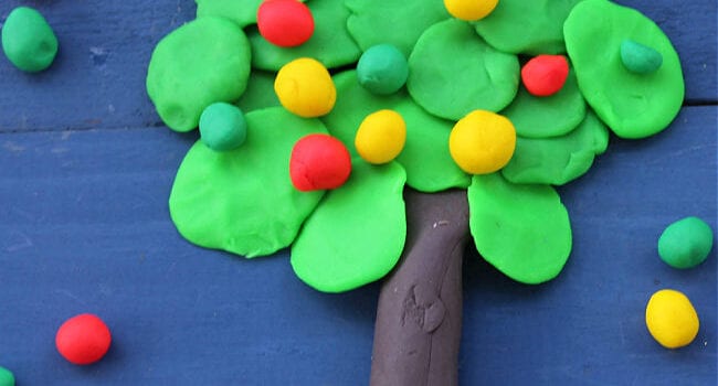 apple tree made out of playdough on a blue background