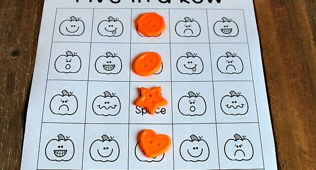 paper with pumpkin pictures and orange buttons set on top