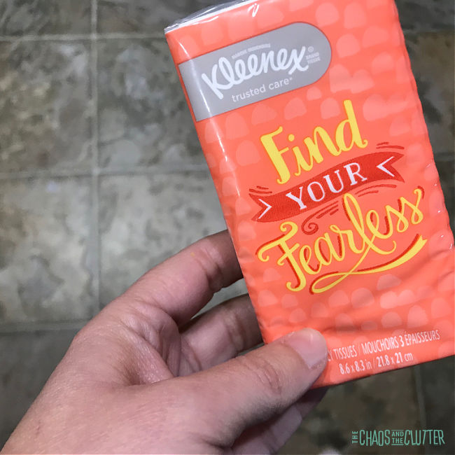 hand holding a small pack of tissues that say "Find Your Fearless"