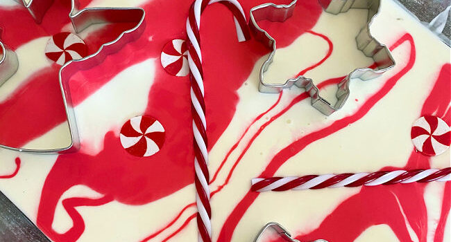 red and white swirls in a dish with candy canes and cookie cutters