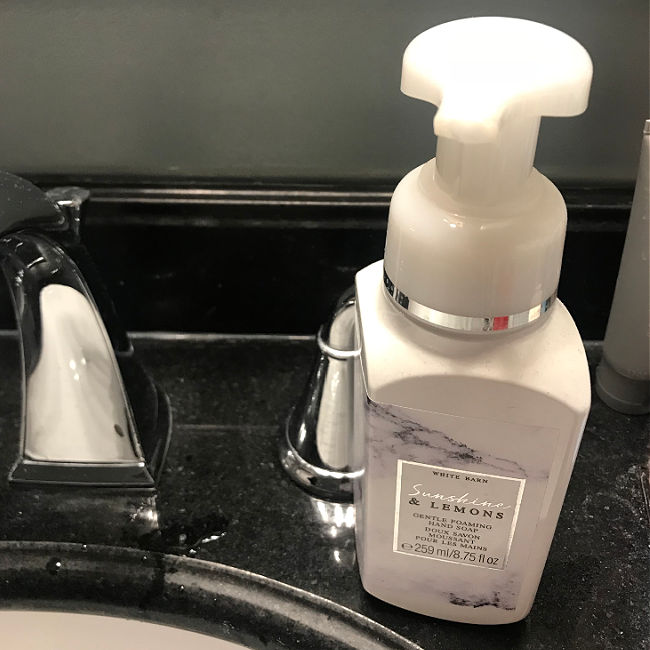 white hand soap bottle on bathroom counter