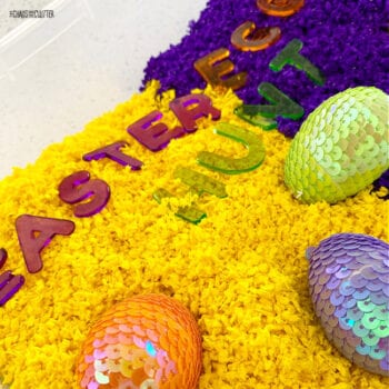 yellow and purple with toy sparkly eggs and the letters to spell Easter Egg Hunt