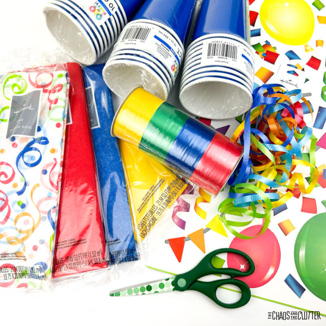 blue party cups, coloured tissue paper, scissors, and ribbon