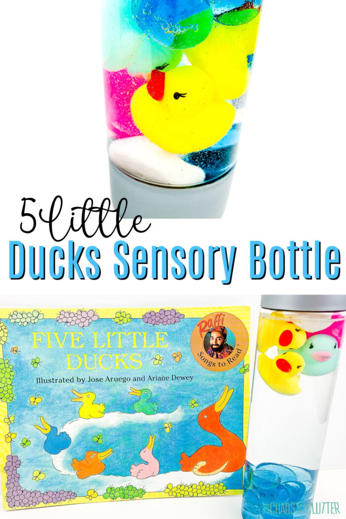 sensory bottle with a rubber duck and blue beads in it next to a children's book