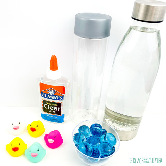 glue, two empty bottles, 5 small rubber duck toys, and blue beads