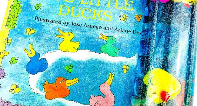 sensory bottle laying on the book 5 Little Ducks